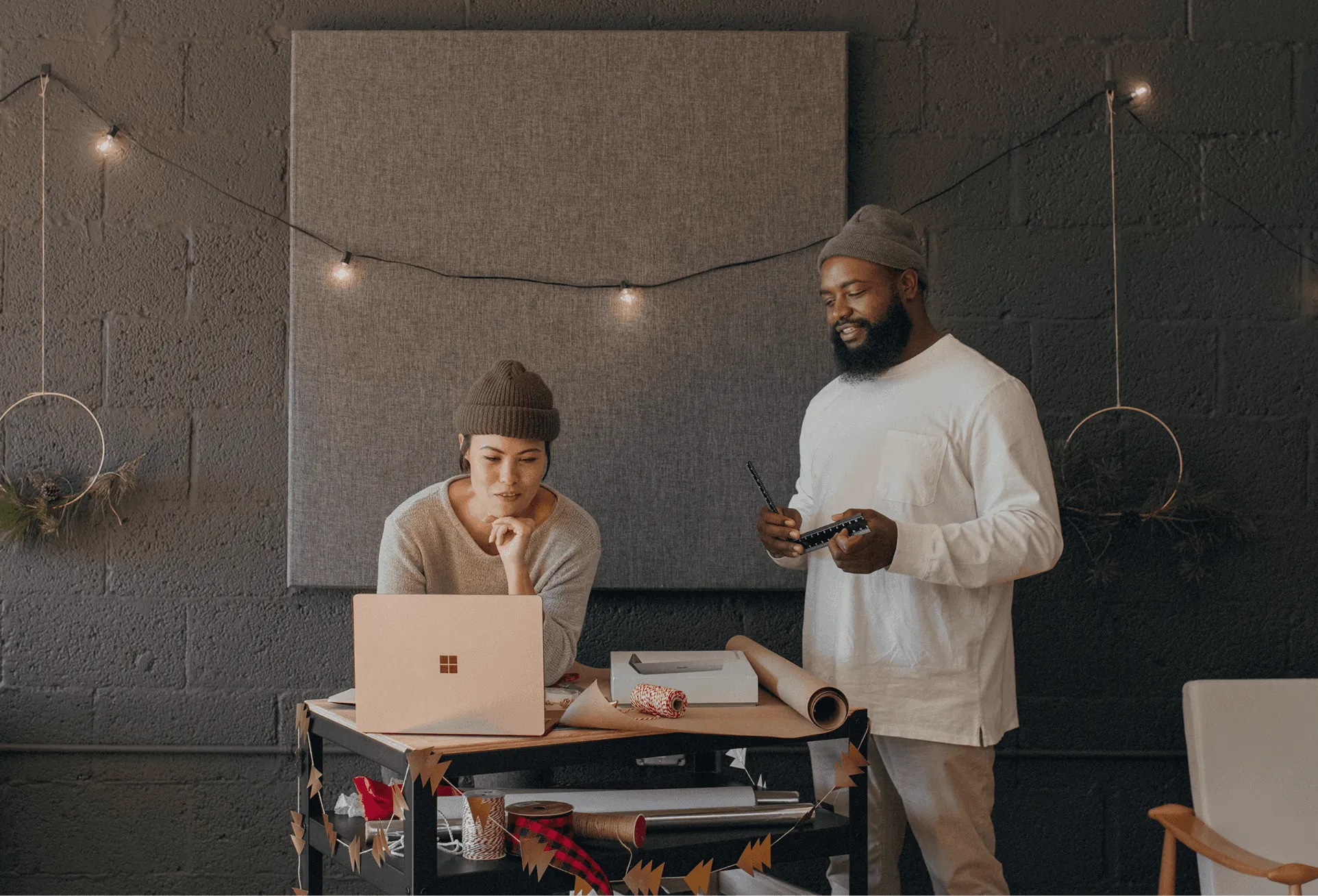 Two engineers reviewing a run on a laptop in a workshop